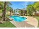 Backyard featuring a sparkling blue in-ground pool, lush landscaping, and a fenced perimeter at 1582 Ocean Neighbors Blvd, Charleston, SC 29412