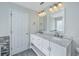 Bright bathroom with white cabinets, double sinks, and marble countertop at 1582 Ocean Neighbors Blvd, Charleston, SC 29412
