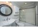 Neutral bathroom featuring a tub-shower with glass doors, and a pedestal sink at 1582 Ocean Neighbors Blvd, Charleston, SC 29412