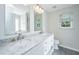 Bright bathroom featuring double sinks, a marble countertop, and white cabinets at 1582 Ocean Neighbors Blvd, Charleston, SC 29412