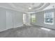 Bedroom with tray ceiling, carpet, and windows allowing natural light at 1582 Ocean Neighbors Blvd, Charleston, SC 29412