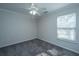 Bedroom with neutral carpet, white trim, and ceiling fan at 1582 Ocean Neighbors Blvd, Charleston, SC 29412