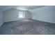 Spacious bonus room featuring neutral carpet, a window, and a ceiling fan at 1582 Ocean Neighbors Blvd, Charleston, SC 29412