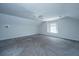 Bonus room with gray carpet, a window, and a ceiling fan at 1582 Ocean Neighbors Blvd, Charleston, SC 29412