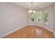 Bright dining area with hardwood floors and large windows overlooking the landscaped yard at 1582 Ocean Neighbors Blvd, Charleston, SC 29412