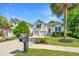 Charming two-story home with a double garage, manicured lawn, and mature trees at 1582 Ocean Neighbors Blvd, Charleston, SC 29412