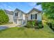 Charming two-story home with attached two-car garage, manicured lawn, and blooming flower beds at 1582 Ocean Neighbors Blvd, Charleston, SC 29412