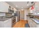 Well-lit kitchen with stainless steel appliances, granite countertops, and hardwood floors at 1582 Ocean Neighbors Blvd, Charleston, SC 29412