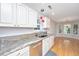Kitchen boasts granite countertops and stainless steel appliances with a view into the breakfast nook at 1582 Ocean Neighbors Blvd, Charleston, SC 29412