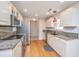 Well-lit kitchen with stainless steel appliances, granite countertops, and hardwood floors at 1582 Ocean Neighbors Blvd, Charleston, SC 29412