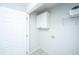 Bright laundry area with white cabinets, utility connections, and doorframe at 1582 Ocean Neighbors Blvd, Charleston, SC 29412