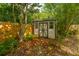 Garden storage shed surrounded by a lush, fenced-in yard at 1582 Ocean Neighbors Blvd, Charleston, SC 29412