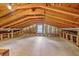 Unfinished attic space with exposed beams, insulation, and natural light at 206 Jimbo Rd, Summerville, SC 29485