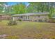 Spacious backyard view of brick home with picnic table and wooden fence on property line at 206 Jimbo Rd, Summerville, SC 29485