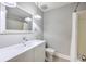 Well-lit bathroom featuring a shower, toilet, sink with updated white cabinets at 206 Jimbo Rd, Summerville, SC 29485