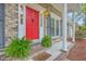 Lovely red door on this brick home with a decorative door knocker and covered porch at 206 Jimbo Rd, Summerville, SC 29485