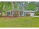 Charming brick home with a red front door, classic shutters, and lush green lawn at 206 Jimbo Rd, Summerville, SC 29485