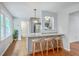 Kitchen island with seating, modern lighting, and open to the dining area at 206 Jimbo Rd, Summerville, SC 29485