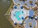 Aerial view of the community pool featuring many lounge chairs, lake access and shaded cabanas at 209 Celestial Blvd, Summerville, SC 29486