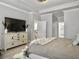 Well-lit bedroom featuring neutral walls, furnishings, and a view into an ensuite bathroom at 209 Celestial Blvd, Summerville, SC 29486