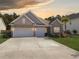 Charming single-Gathering home featuring a two-car garage, manicured lawn, and beautiful brick and siding details at 209 Celestial Blvd, Summerville, SC 29486