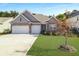 Charming single-Gathering home featuring a two-car garage, manicured lawn, and beautiful brick and siding details at 209 Celestial Blvd, Summerville, SC 29486