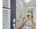 Elegant foyer featuring a marble accent wall, decorative console table, and hardwood flooring that flows into the living area at 209 Celestial Blvd, Summerville, SC 29486