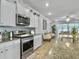 Bright kitchen featuring stainless steel appliances, light grey backsplash, and ample cabinet space at 209 Celestial Blvd, Summerville, SC 29486