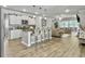 Open concept kitchen with a large island with barstool seating, stainless appliances, and access to the living room at 209 Celestial Blvd, Summerville, SC 29486