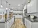 Elegant kitchen with white cabinetry, granite counters, stainless steel appliances, and breakfast bar at 209 Celestial Blvd, Summerville, SC 29486