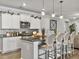 Stylish kitchen with white cabinets, granite counters, stainless appliances, and island with seating at 209 Celestial Blvd, Summerville, SC 29486