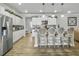 Spacious kitchen with stainless steel appliances, granite counters, and eat-in island with stylish pendant lighting at 209 Celestial Blvd, Summerville, SC 29486