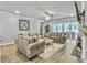 Elegant living room with large sofas, fireplace, and sliding glass doors to patio at 209 Celestial Blvd, Summerville, SC 29486