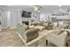 Bright open-concept living room with sofas, fireplace, TV, and seamless transition to kitchen at 209 Celestial Blvd, Summerville, SC 29486