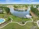 Aerial view showcasing the community's lake, swimming pool, boathouse, and walking paths at 246 Calm Water Way, Summerville, SC 29486