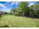 Large backyard with a black iron fence, lush lawn, and mature trees at 246 Calm Water Way, Summerville, SC 29486