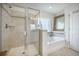 Bright bathroom featuring a tile and glass shower enclosure and a soaking tub at 246 Calm Water Way, Summerville, SC 29486
