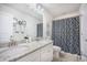 Bathroom featuring a double vanity with granite countertops, and a shower with patterned curtain at 246 Calm Water Way, Summerville, SC 29486