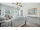 Bright bedroom with a ceiling fan, windows, and artwork above a decorative table at 246 Calm Water Way, Summerville, SC 29486