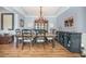 Dining room features wood floors, elegant lighting, and built-in serving area at 246 Calm Water Way, Summerville, SC 29486