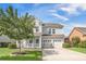 Charming two-story home with a manicured lawn, two-car garage, and inviting porch with blue furniture at 246 Calm Water Way, Summerville, SC 29486