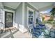 Inviting front porch with rocking chairs, a floral rug, and a charming welcome mat at the entrance at 246 Calm Water Way, Summerville, SC 29486