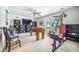 Spacious game room with carpet, ceiling fan, foosball table, exercise equipment, and built-in shelving at 246 Calm Water Way, Summerville, SC 29486