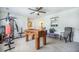 Recreation room with exercise equipment, carpet, ceiling fan, and foosball table near the bathroom at 246 Calm Water Way, Summerville, SC 29486