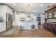 Bright kitchen features stainless steel appliances, a large island, hardwood floors and a stylish chandelier at 246 Calm Water Way, Summerville, SC 29486