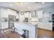 Bright kitchen features stainless steel appliances, a large island, hardwood floors and a stylish chandelier at 246 Calm Water Way, Summerville, SC 29486
