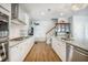The kitchen features granite countertops, white cabinets, stainless steel appliances and hardwood floors at 246 Calm Water Way, Summerville, SC 29486