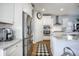 The kitchen has white cabinets, stainless steel appliances, granite countertops, and hardwood floors at 246 Calm Water Way, Summerville, SC 29486