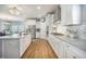 Bright kitchen features stainless steel appliances, granite countertops, white cabinets, hardwood floors and a chandelier at 246 Calm Water Way, Summerville, SC 29486