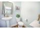Powder room with pedestal sink, toilet, and decorative mirror at 246 Calm Water Way, Summerville, SC 29486